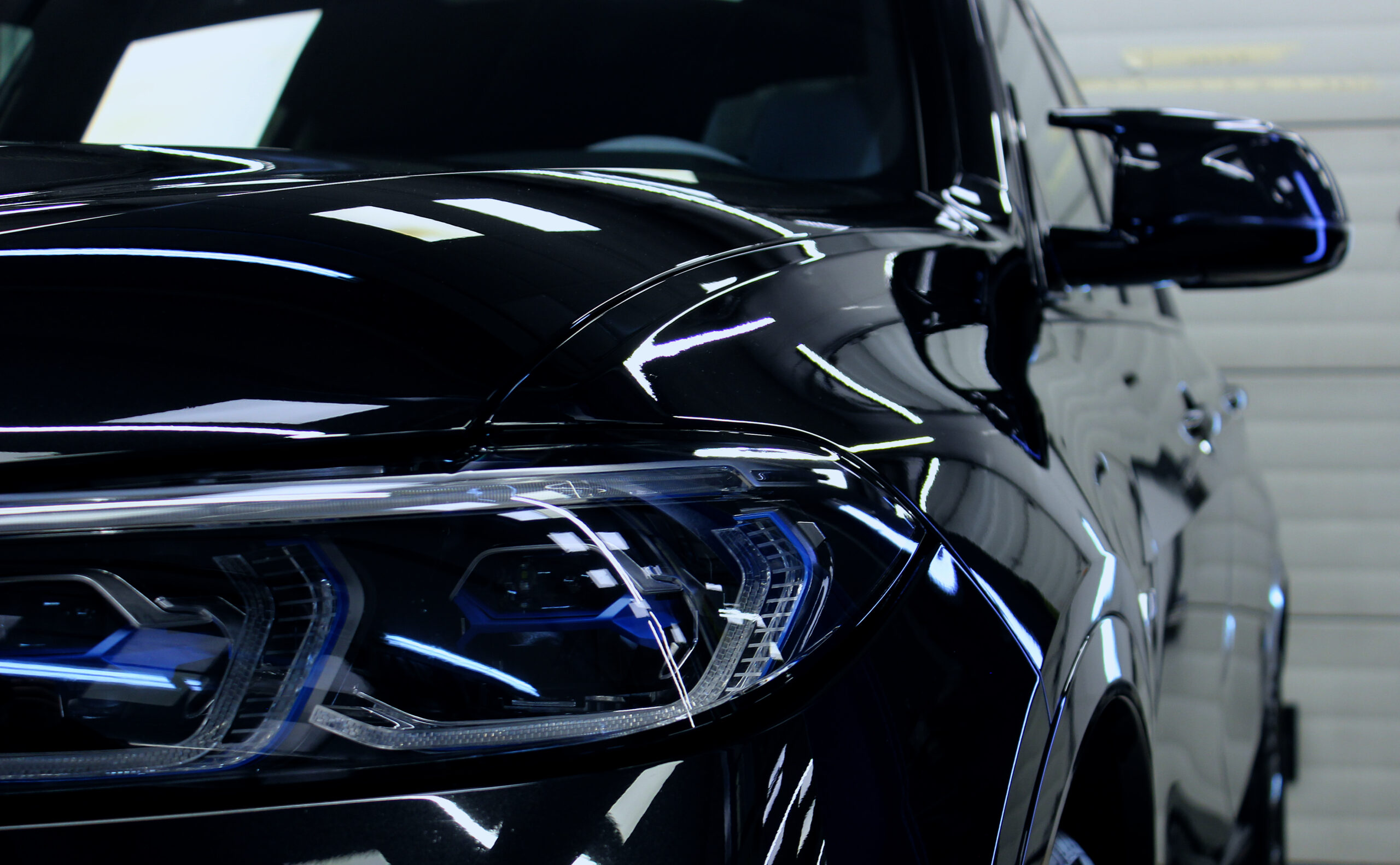 sleek-black-luxury-car-headlight-reflective-body